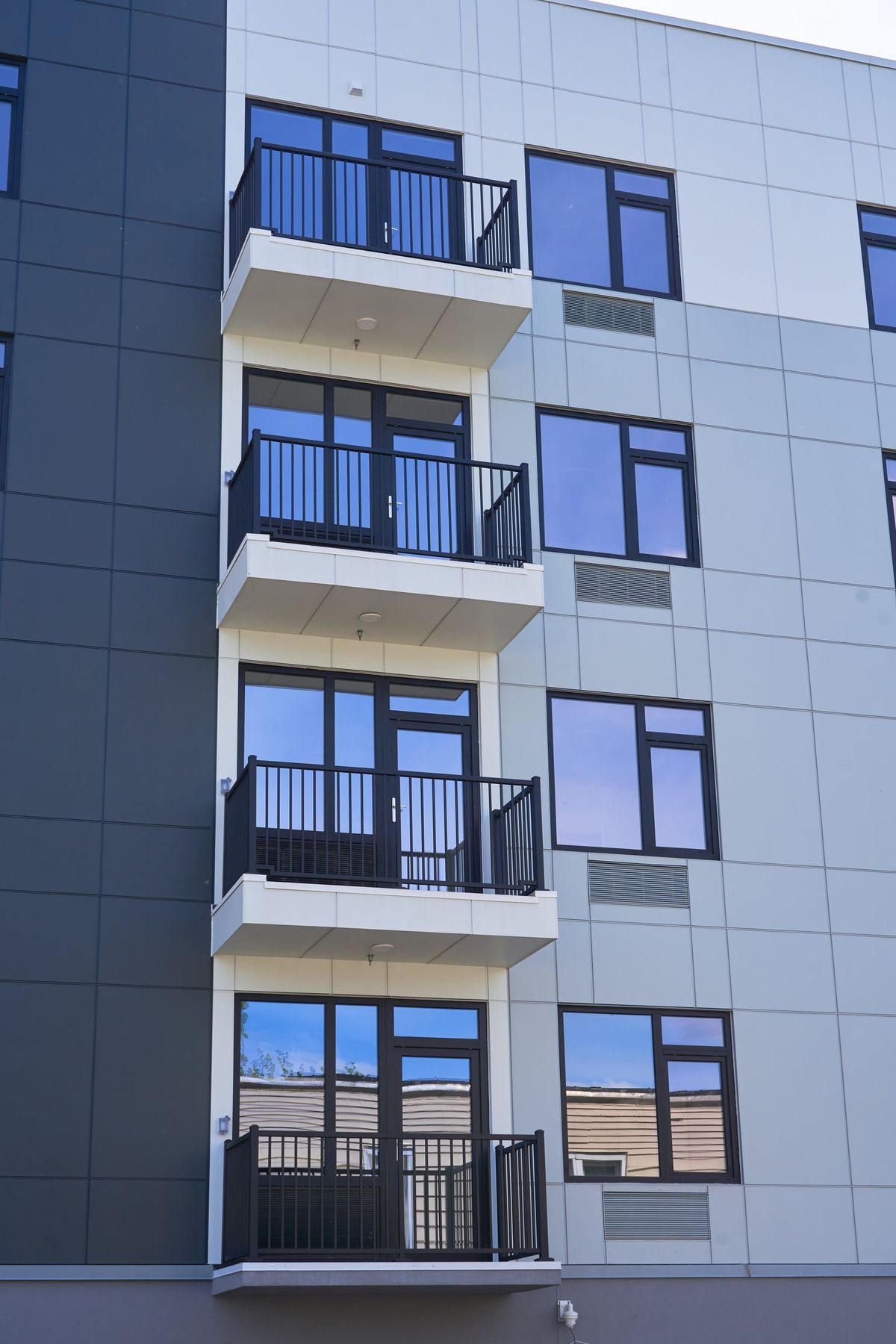 A PTAC louver glazed into a window frame, seen from a balcony